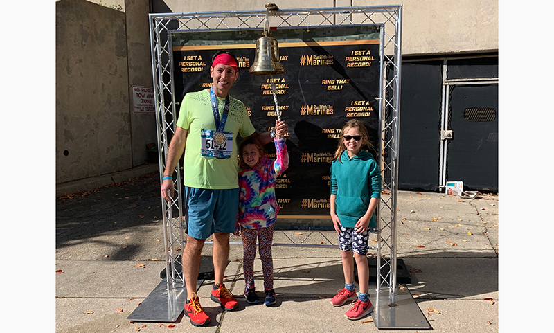 2022: Dave ringing the PR bell after the Marine Corps Marathon 50K